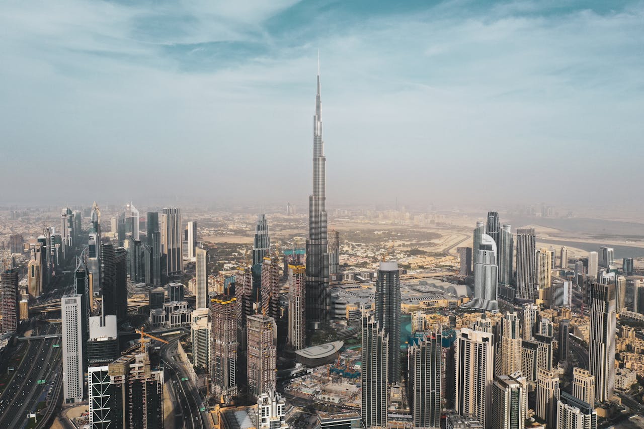 A breathtaking aerial view of Dubais skyline featuring Burj Khalifa amidst modern skyscrapers under a clear sky.
